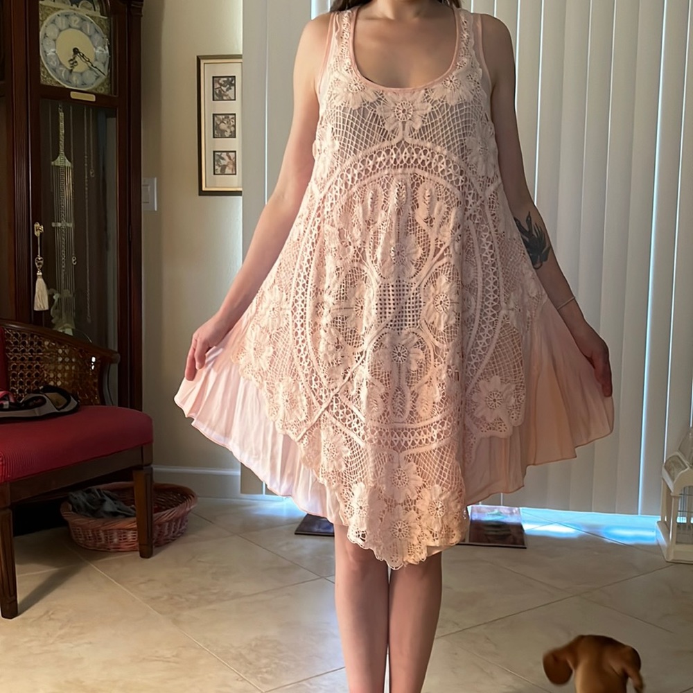 Small peach beach cover up in handkerchief style.